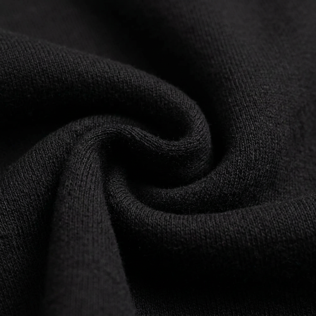 Macro detail of the soft black fleece knit texture of the Culture Creators x Karl Kani oversized hoodie