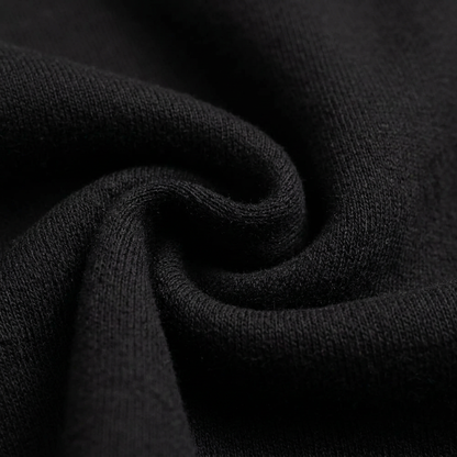 Macro detail of the soft black fleece knit texture of the Culture Creators x Karl Kani oversized hoodie